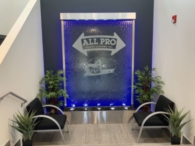 Glass-Water-Wall-with-Stainless-Steel-Frame-and-Etched-Vinyl-Logo