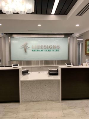 Glass-Water-Wall-with-Stainless-Steel-Frame-and-Off-Mounted-Logo-for-Lifesigns-in-Memphis-TN