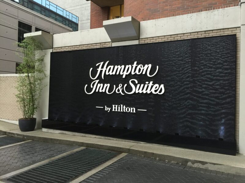 Black Scored Acrylic Water Wall Aquafall with Logo for Hampton Inn Vancouver Canada