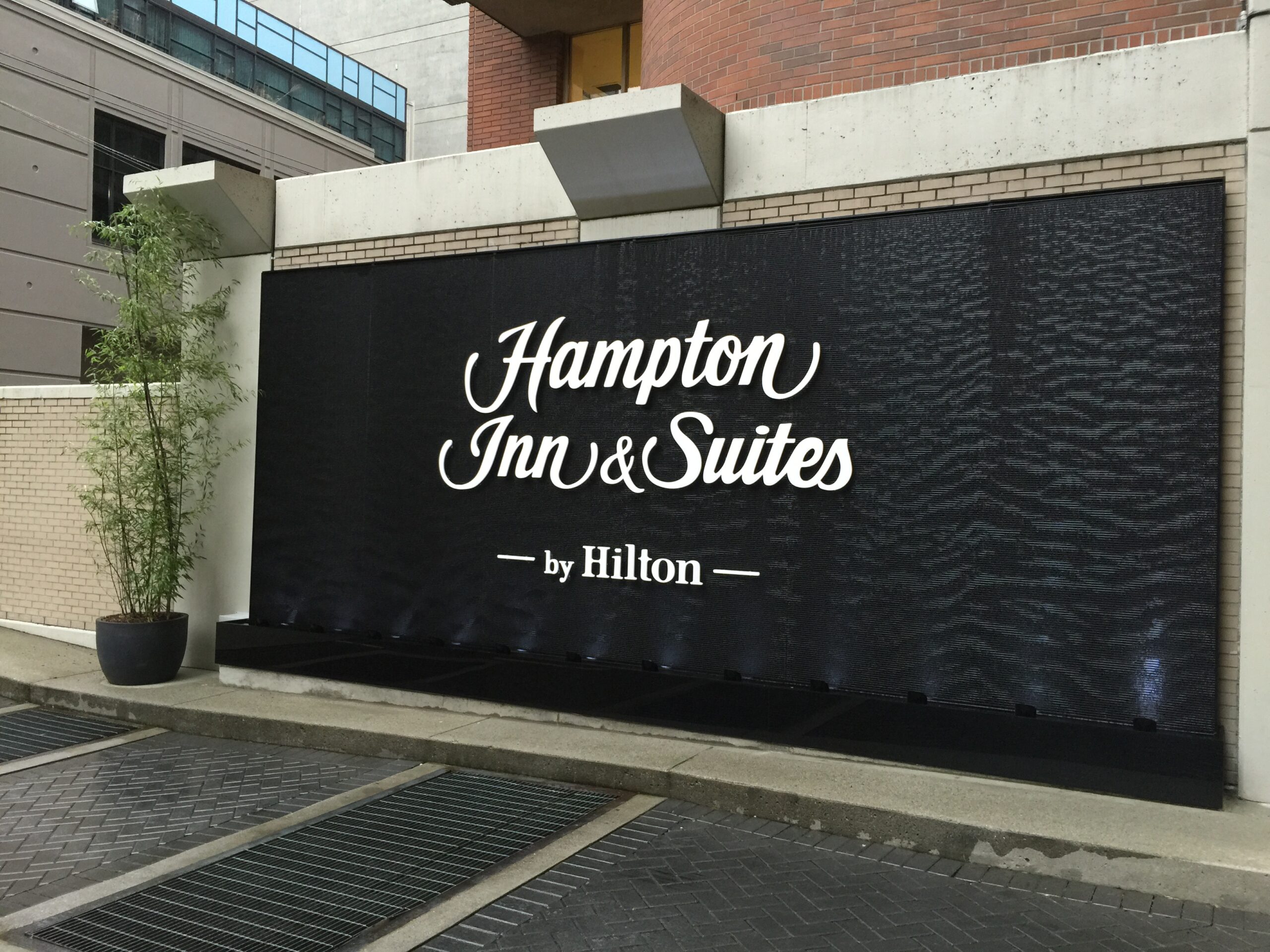 Black Scored Acrylic Water Wall Aquafall with Logo for Hampton Inn Vancouver Canada