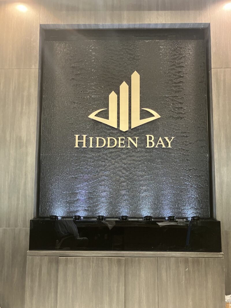 Black Scored Acrylic Water Wall with Logo at  Hidden Bay in Aventura (Miami), FL