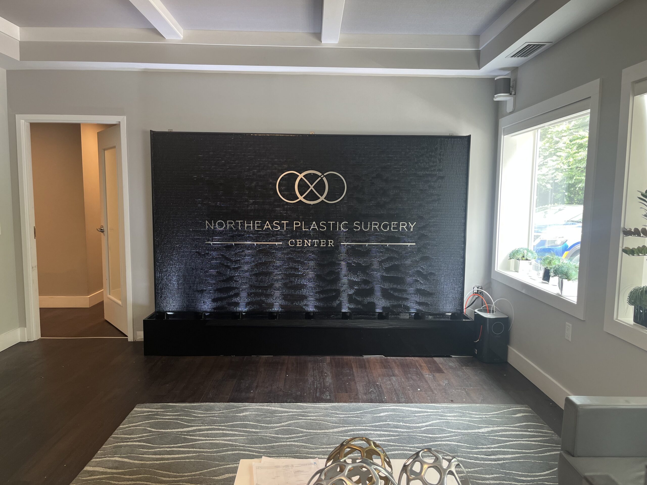 Black Scored Acrylic Water Wall with Logo for NORTHEAST PLASTIC SURGERY CENTER in Old Lyme Connecticut 2 scaled