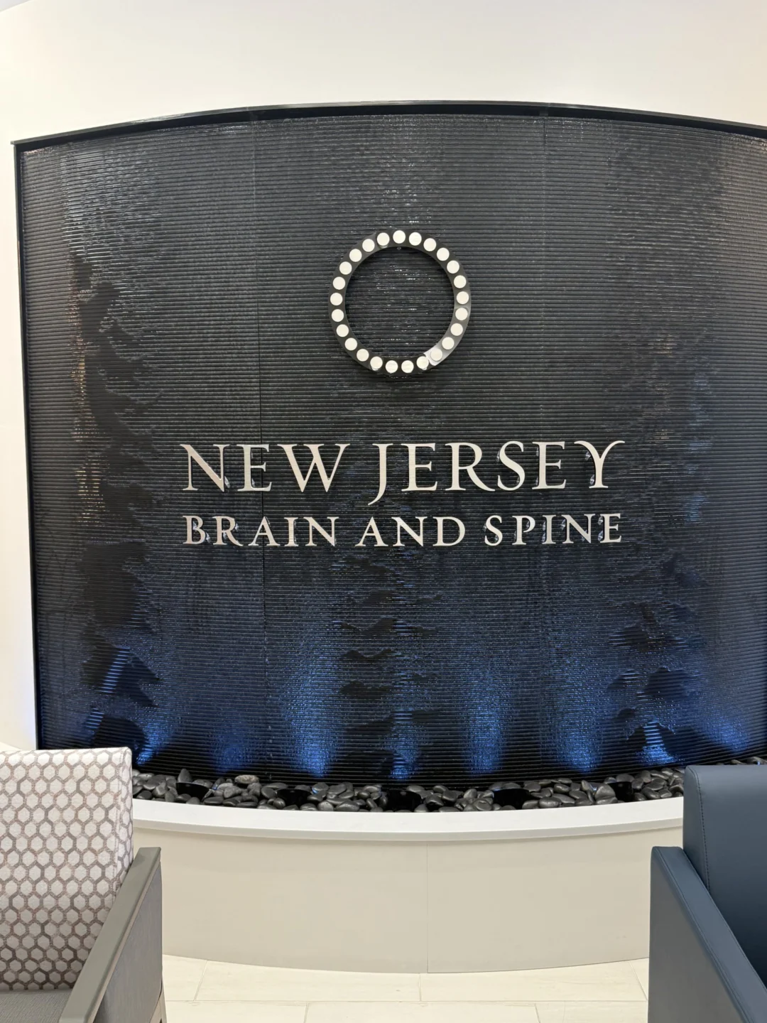 Curved Black Scored Acrylic Aquafall Water Wall with Logo for New Jersey Brain and Spine in Paramus, NJ