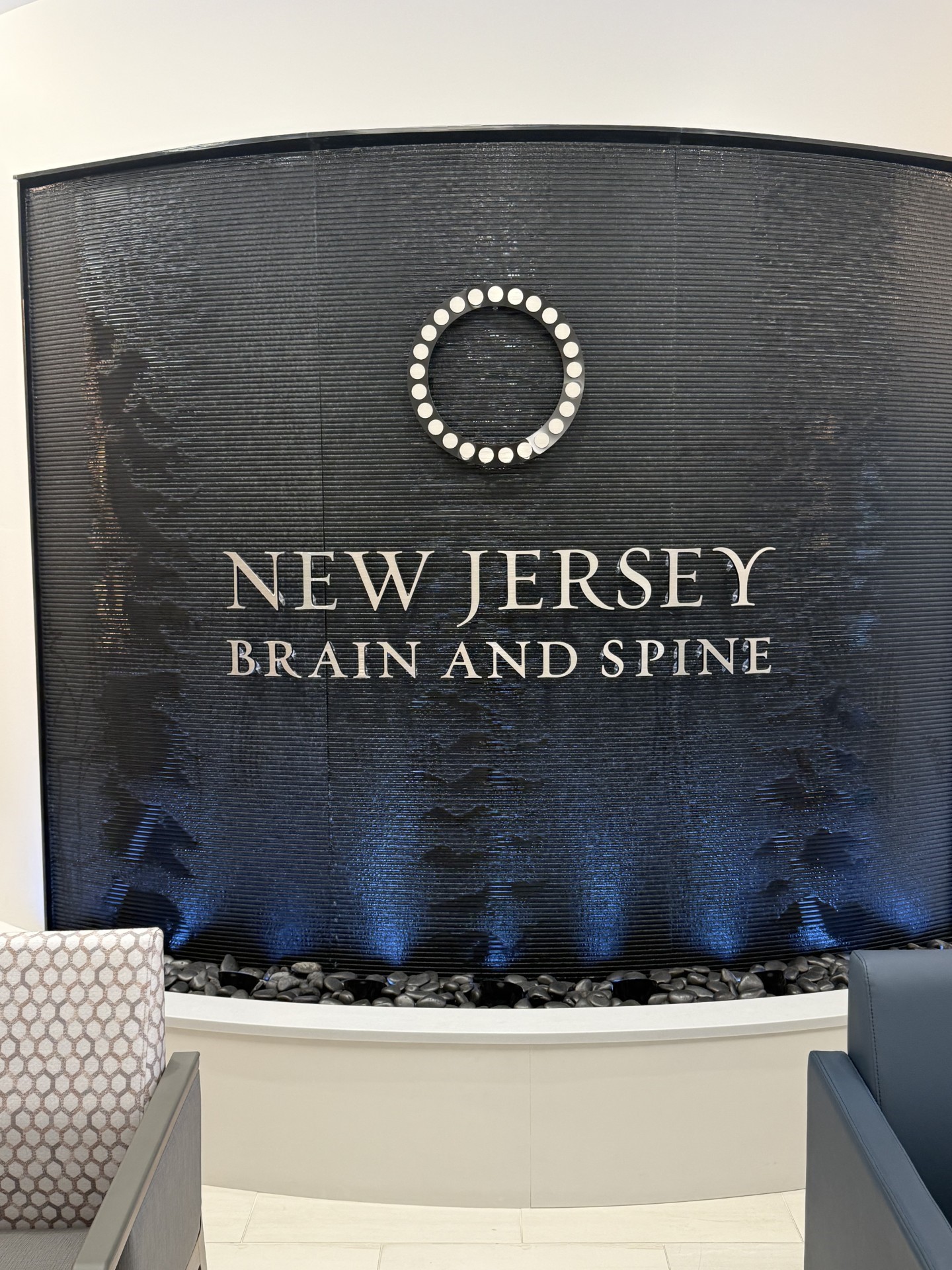 Curved Black Scored Acrylic Aquafall Water Wall with Logo for New Jersey Brain and Spine in Paramus, NJ