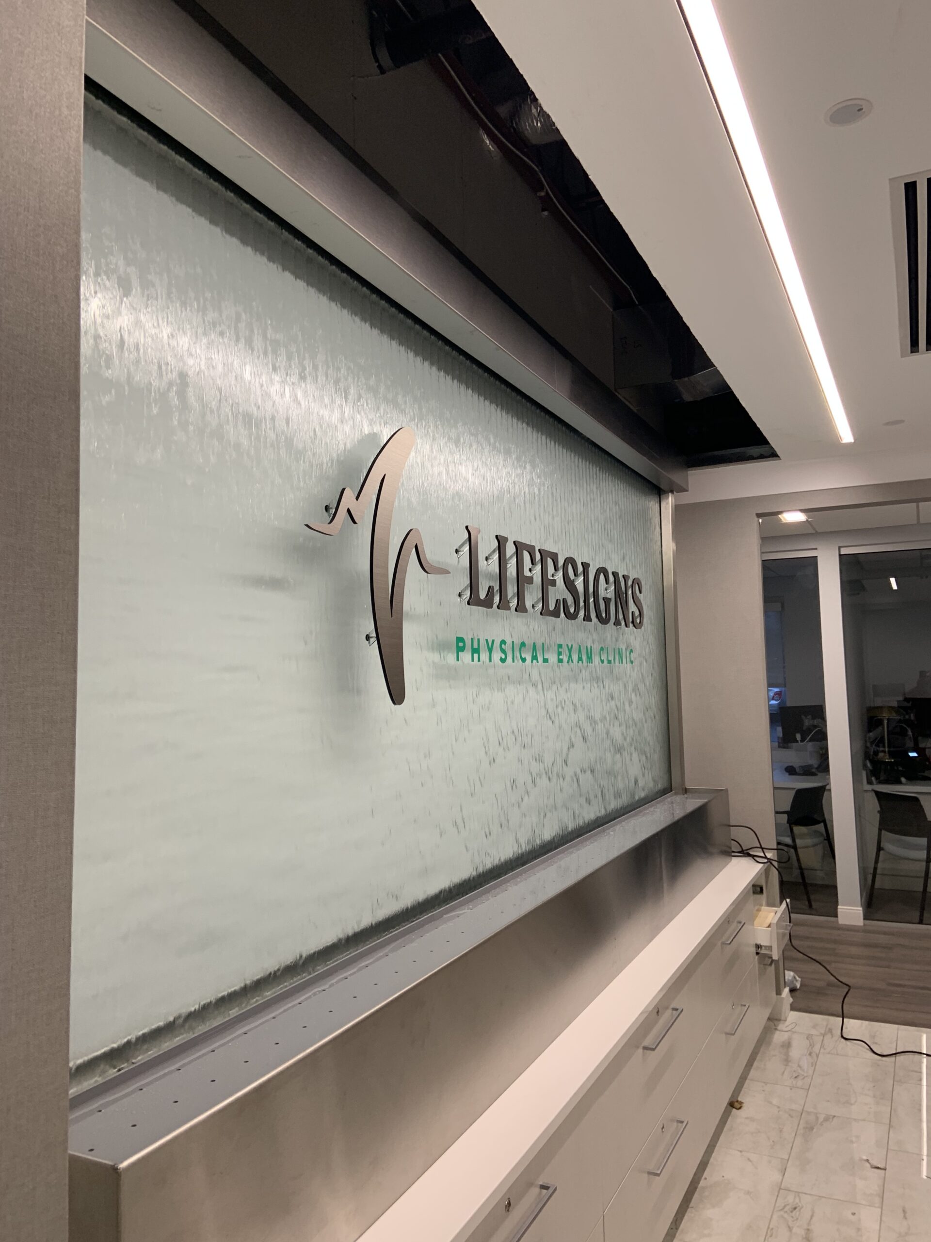 Glass Water Wall with Stainless Steel Frame and Off Mounted Logo for Lifesigns in Memphis TN 2 scaled