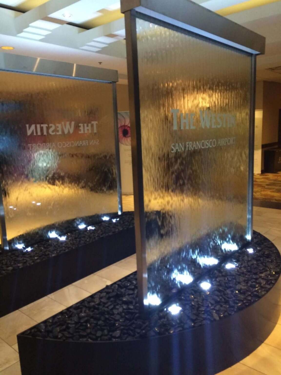 Glass and Stainless Water Wall with Half Circle Curved Basin at Westin San Franciso Airport 1 Glass and Stainless Water Wall with Half Circle Curved Basin at Westin San Franciso Airport 3