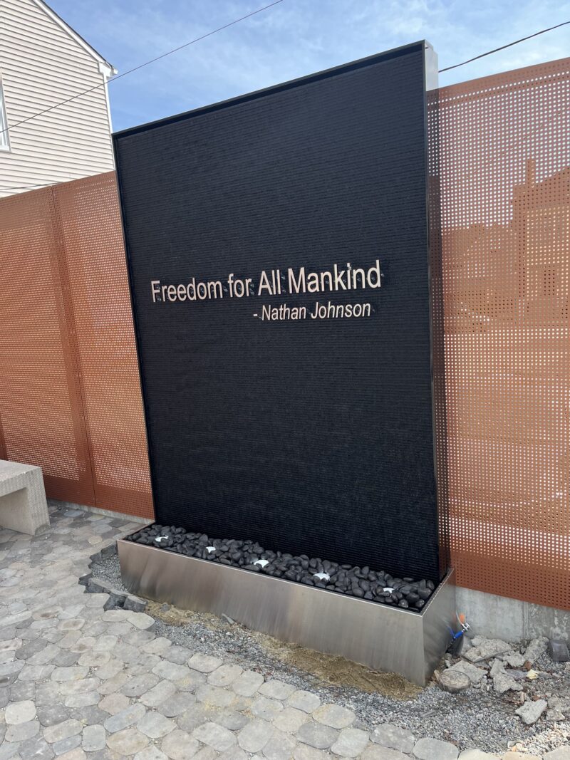 Outdoor Black Scored Acrylic Water Wall with Logo for Abolition Row Park in New Bedord, Massachusetts
