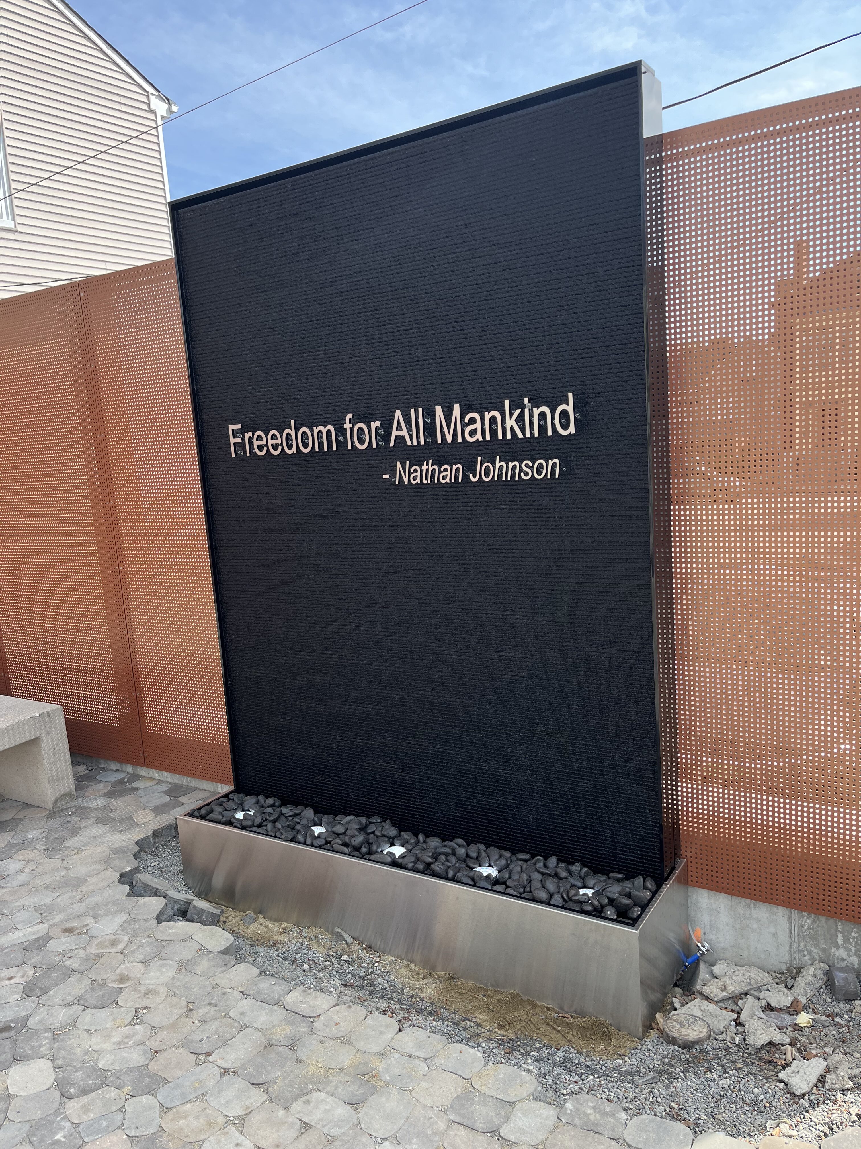 Outdoor Black Scored Acrylic Water Wall with Logo for Abolition Row Park in New Bedord, Massachusetts