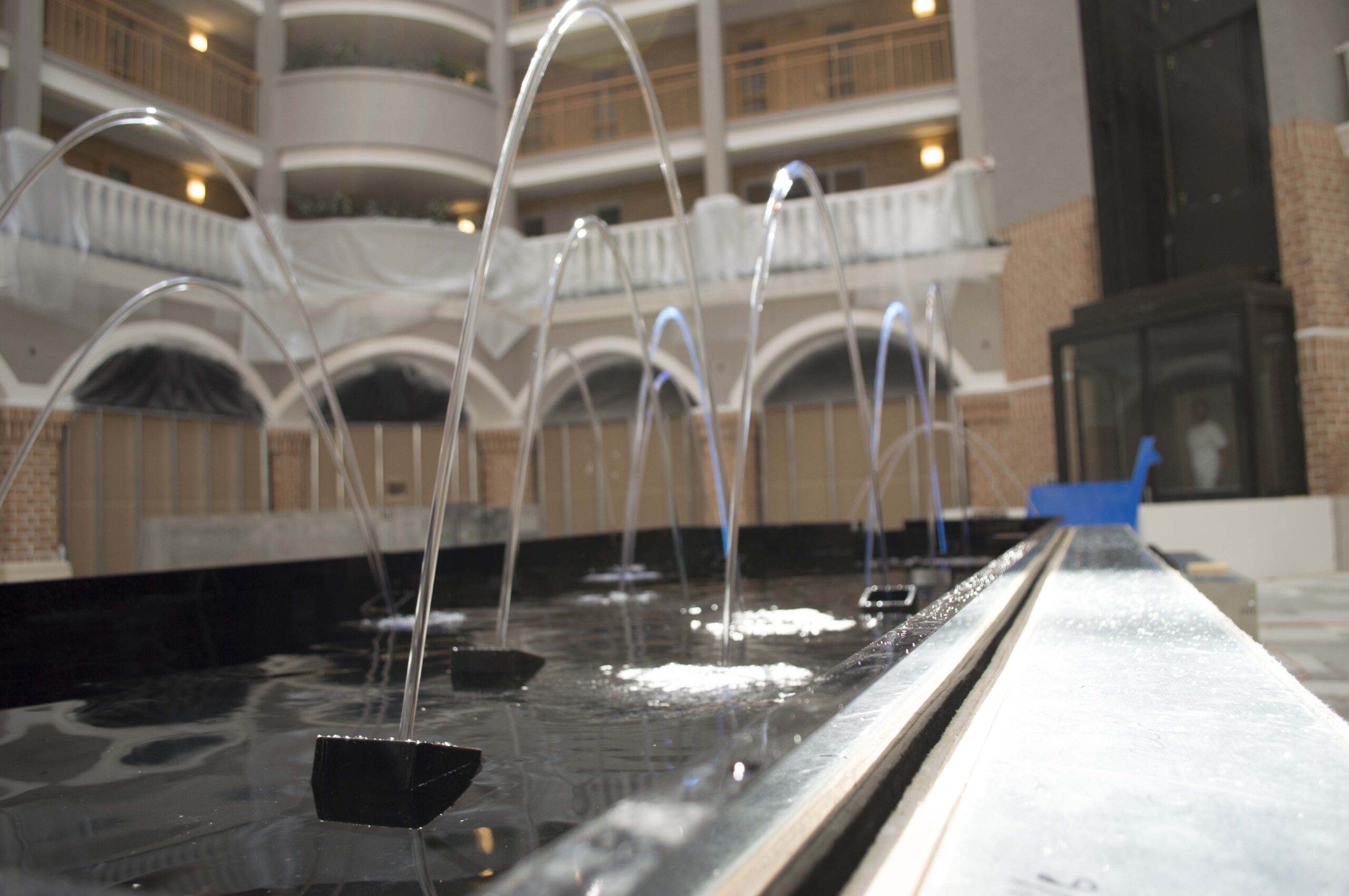 Relfection Pool with Arching Fountain Jets at Embassy Suites Orlando Florida 3 scaled