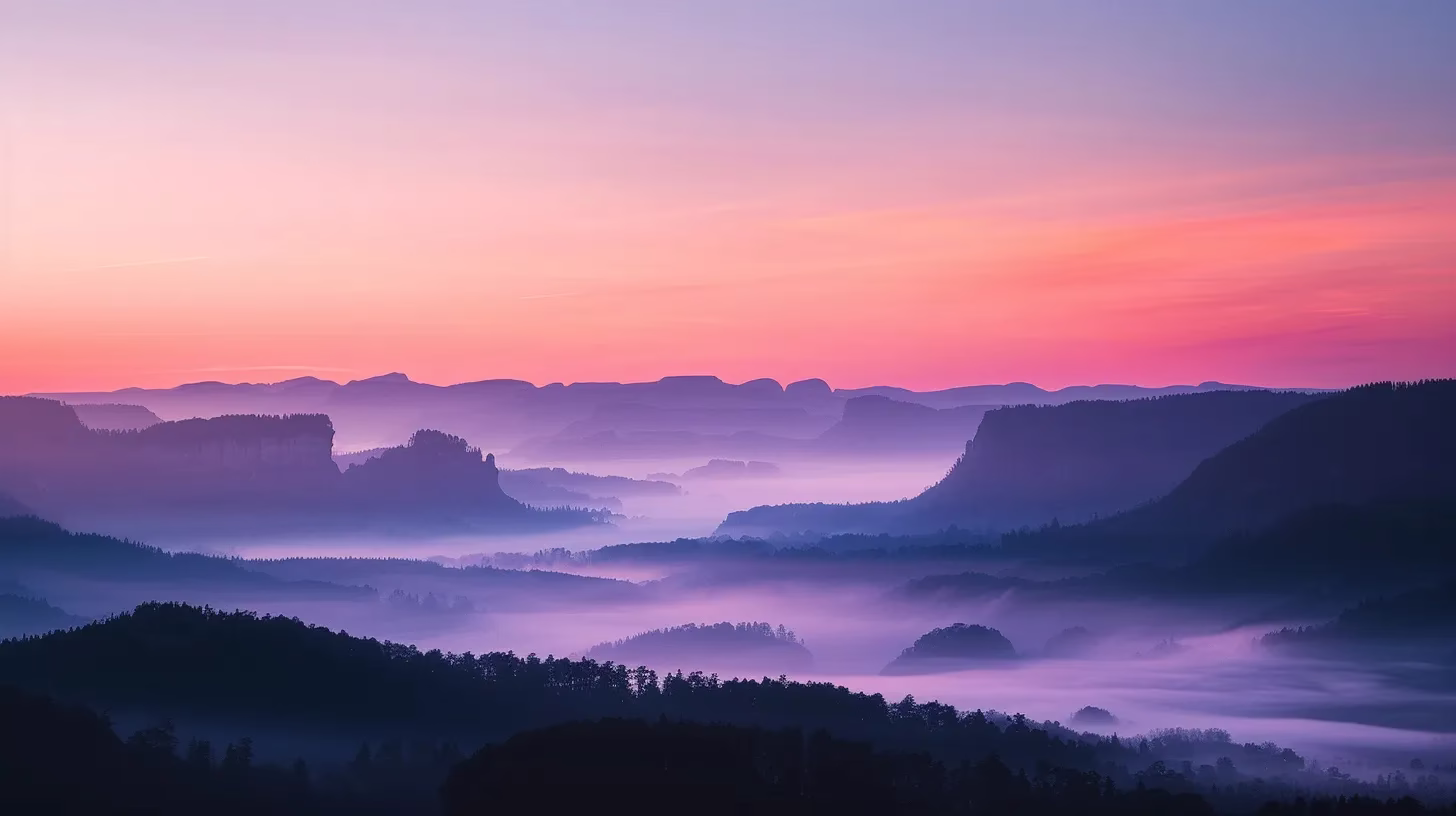 a breathtaking mountaintop landscape at sunrise, where vibrant orange and pink hues illuminate the rugged peaks while a tranquil mist blankets the valleys below.