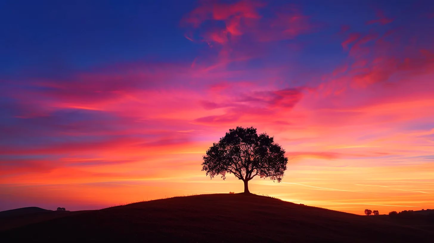 a vibrant sunset paints the sky in hues of orange and pink as a solitary tree stands majestically on a hilltop, silhouetted against the glowing horizon.